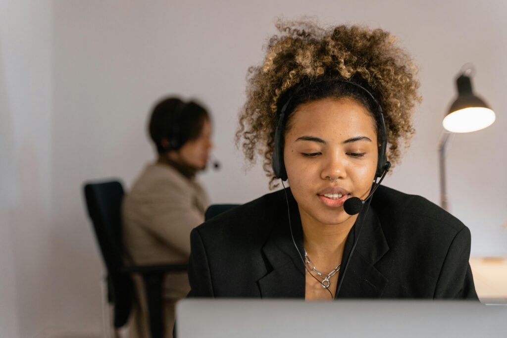 Female customer support agent in an office wearing a headset for effective communication.